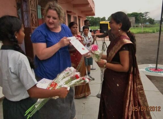 Melinda Parker distributes bouquets at Gyanankur in 2012