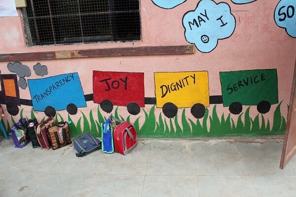A wall painted with Gyanankur's core values of Transparency, Joy, Dignity and Service