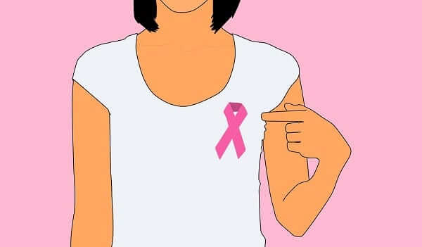 woman wearing breast cancer pin