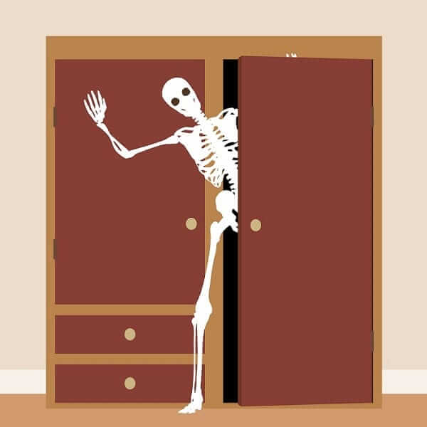 skeleton waving from a cupboard or clo
