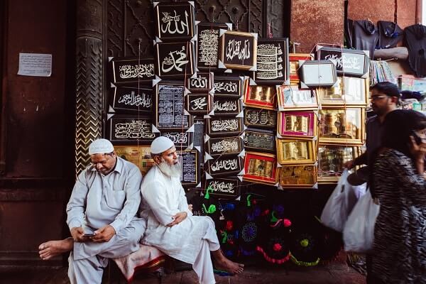 Muslim men sit outside the Jama Masjid in Delhi, India