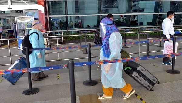 indians in ppe at airport