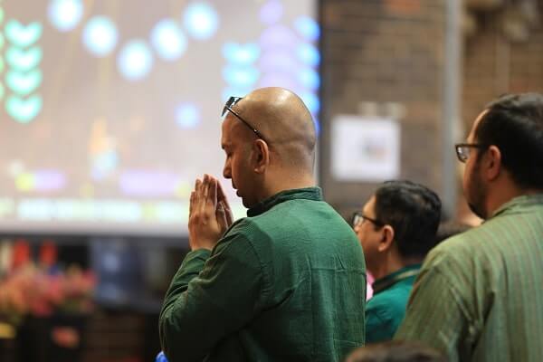 Worshipper praying at Durga Puja celebration