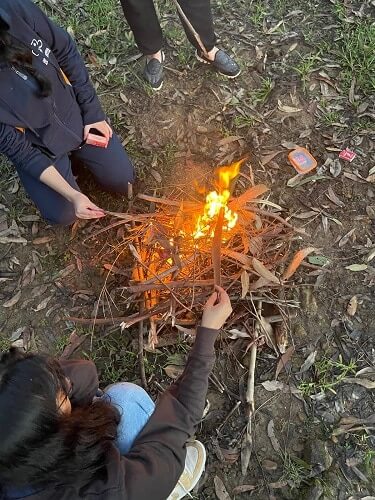 Leaders lighting campfire