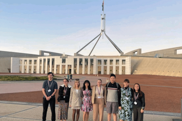 Aayushi Khillan and her fellow Youth Advisory Board members in front of Parliament house in Canberra