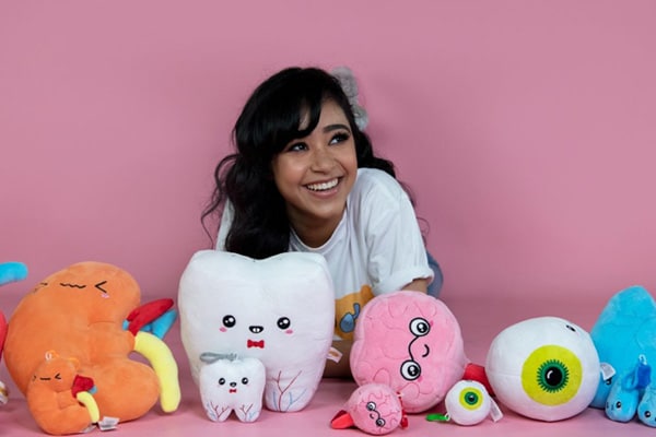Aayushi poses with anatomy shaped plush toys for her start-up, Body Buddies