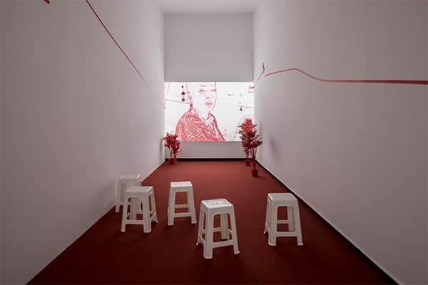 A red screen; still from Sen's 29-minute-long video work 'I have only one language; it is not mine'.