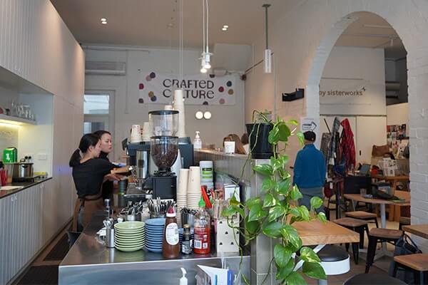 A busy cafe, people move around. 