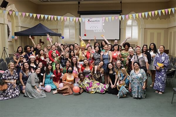 A large group of diverse women pose for a photo.