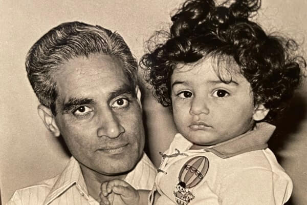 a black and white photo of a father holding a child. 