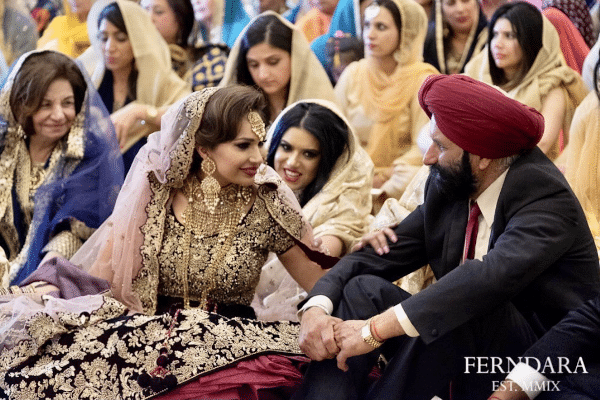 a bride touches the arm of her father at a wedding