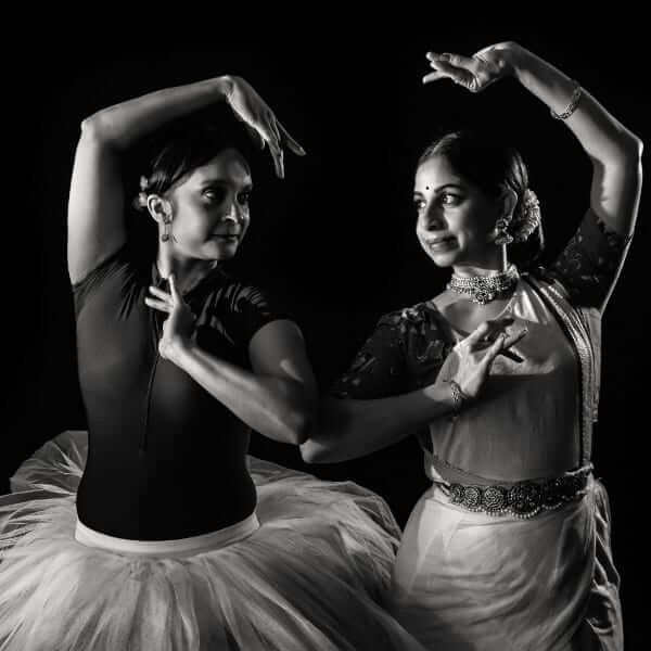 Deepa Mani holds a Bharatanatyam pose, and Sheena Chundee holds a ballet pose, in a black and white promotional picture.