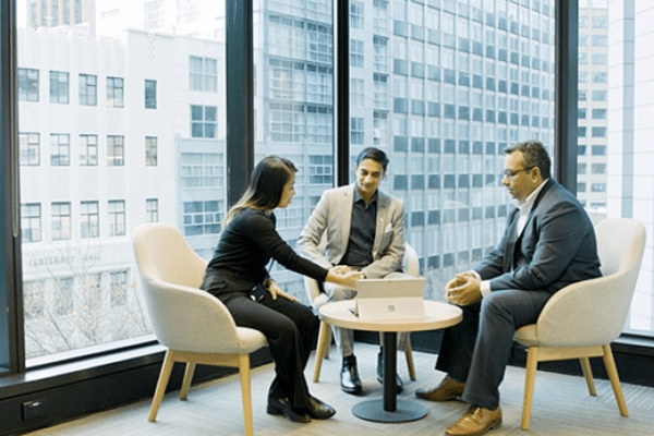 Rohit Joshi meets with representatives of Invest Victoria in a high rise building.