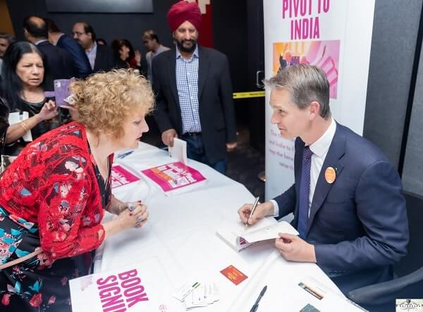 Andrew Charlton signing copies of his book