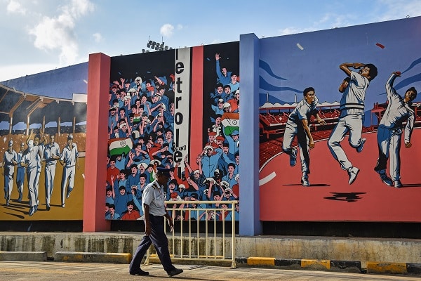 A security guard walks in front of the murals of Indian cricket players painted on a wall inside M. A. Chidambaram Stadium, ahead of the ICC Men's Cricket World Cup 2023, in Chennai, India, 15 September 2023. India is set to host the ICC Men's Cricket World Cup 2023 between 5 October to 19 November 2023. EPA/IDREES MOHAMMED