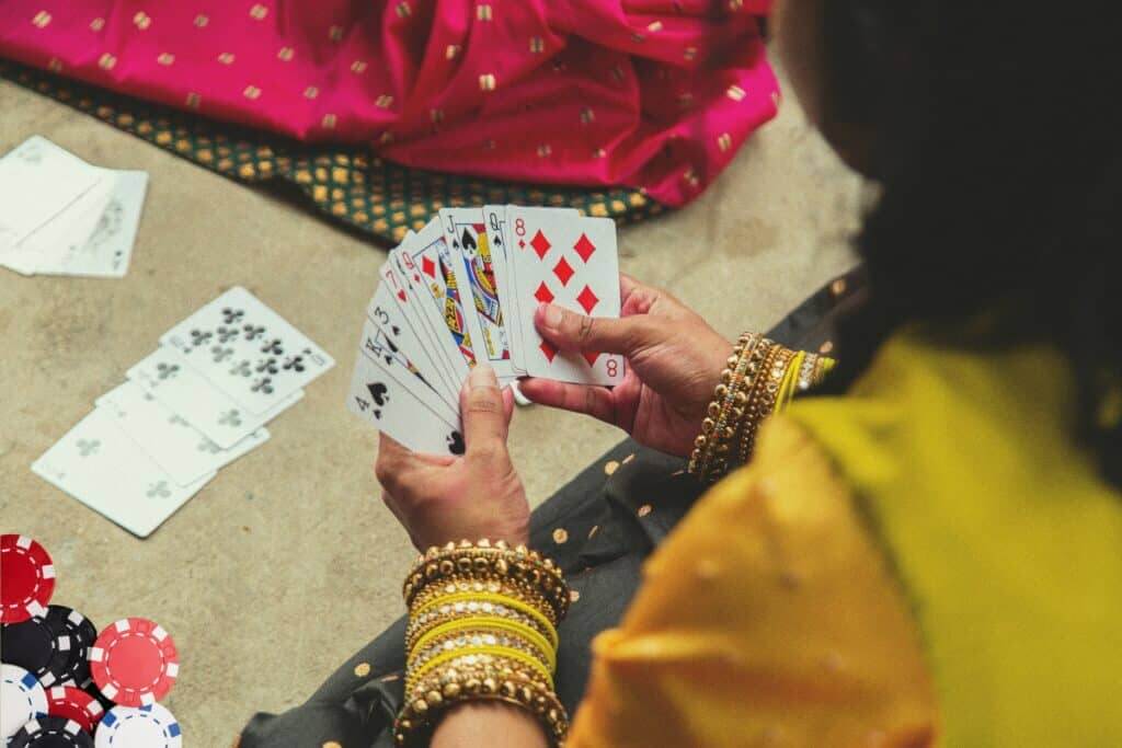 Indian woman with bangles playing cards 