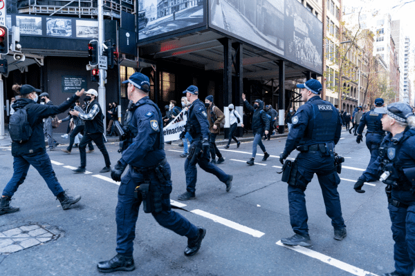 a group of police officers in Sydney's cbd responding to a protest