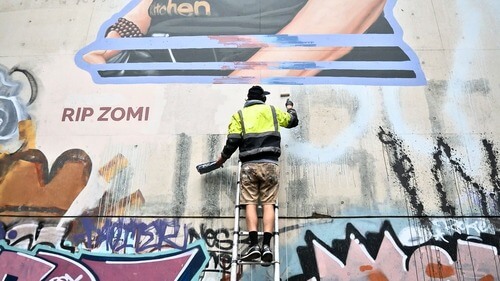 Artist Peter Seaton painting Zomi Frankcom mural