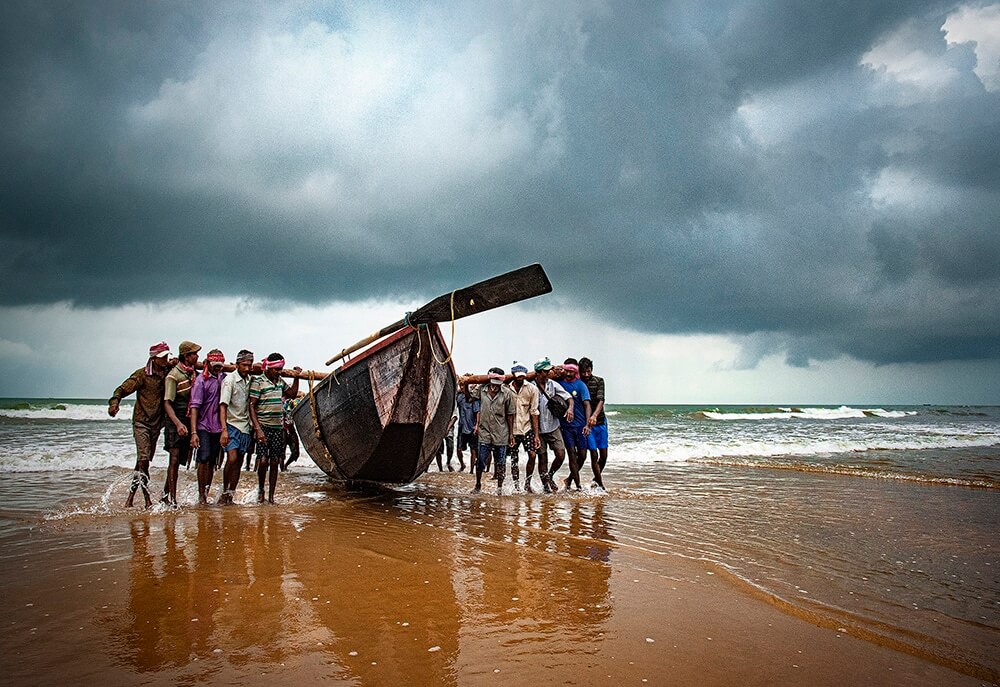 Photo of men near a boat