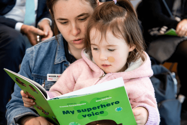 child and parent reading book