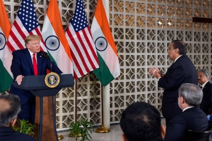 Trump interacting with Mukesh Ambani during a meeting with business leaders at the US Embassy in New Delhi in 2020