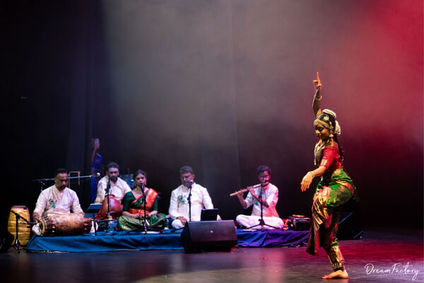 nandana on stage with musicians